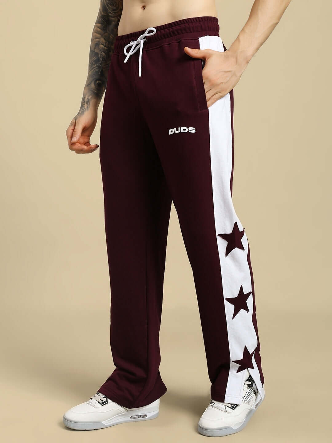 Men's maroon joggers with white stars and side stripes, relaxed fit, DUDS brand, customizable, ideal for casual wear.