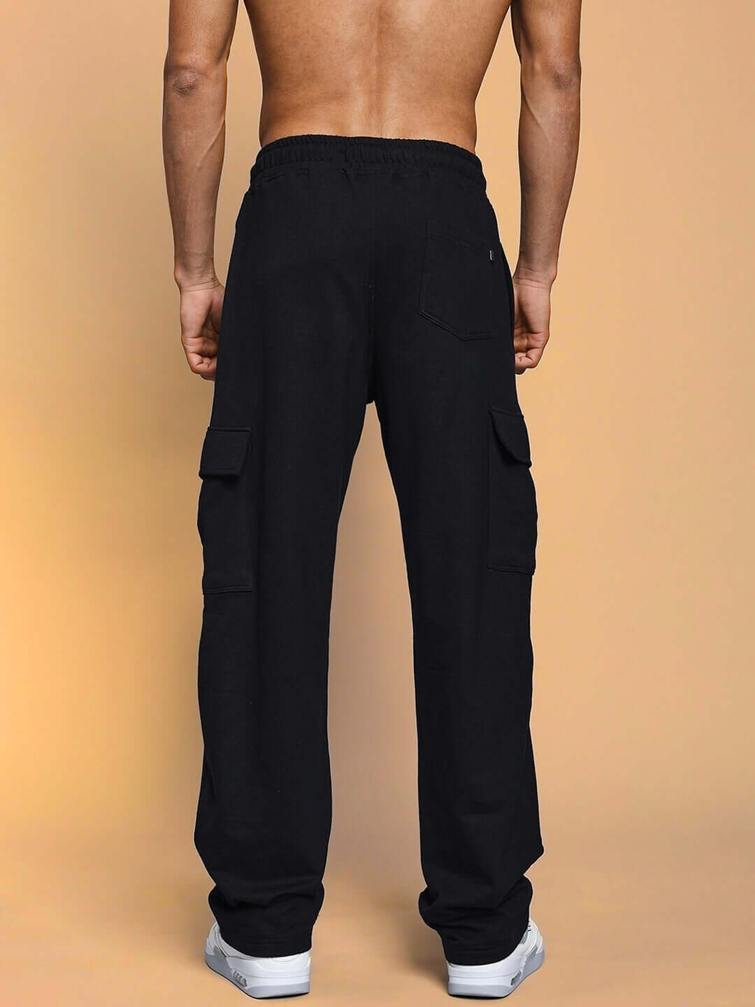 Back view of man wearing BRUNO 5 Pocket Cargo Pants in black, showcasing comfortable fit and functional pockets. Available for custom fit.
