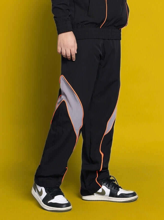 Child wearing Bullet relaxed fit black cargo pants with orange accents showcasing customizable casual wear.