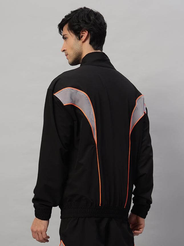 Model wearing black Bullet Parachute Jacket showcasing back design with orange piping, available in custom fit from DUDS.