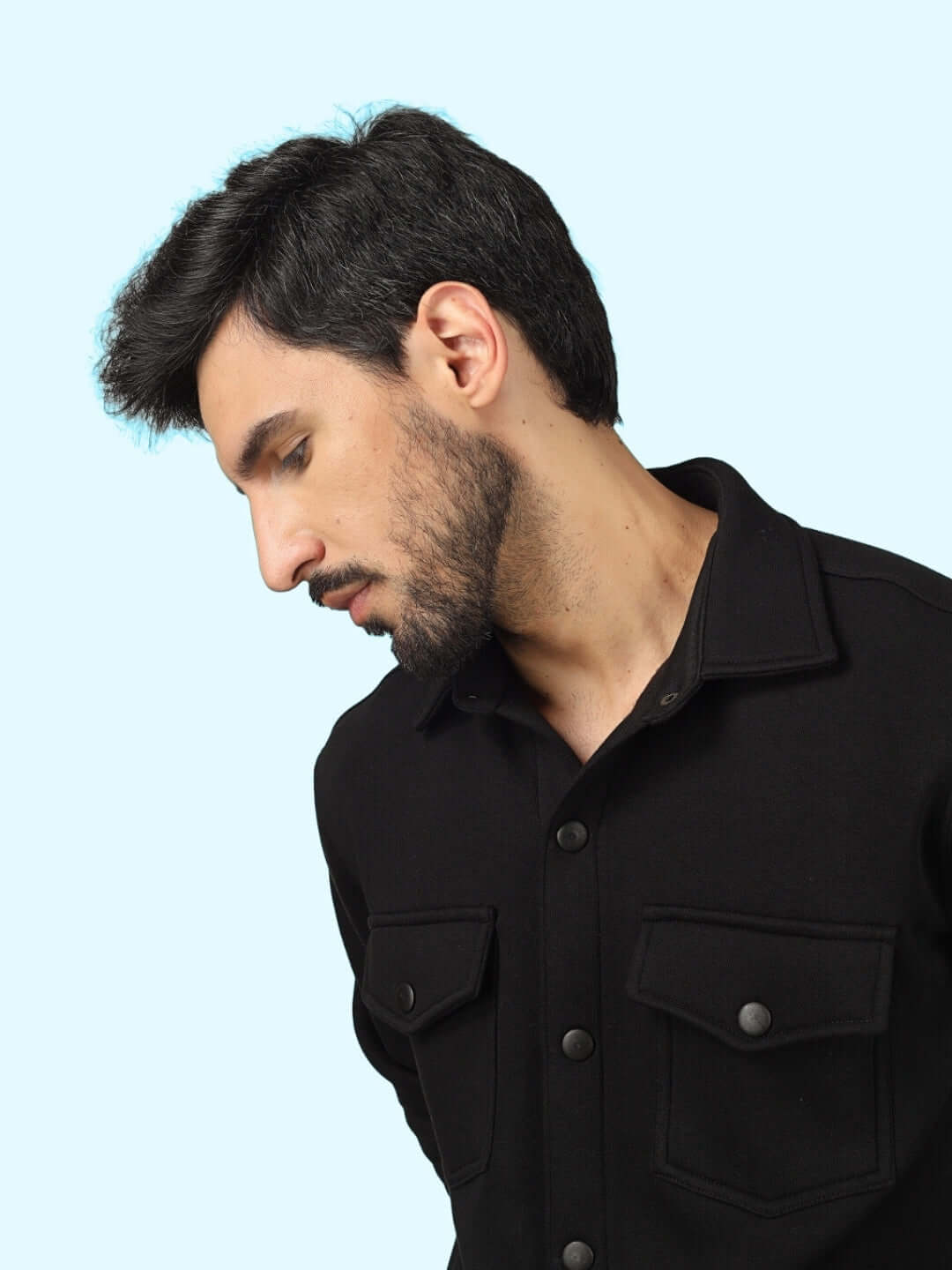 Man wearing black overshirt from Burly Black Overshirt-Cargo Pant Co-Ord Set on light blue background.