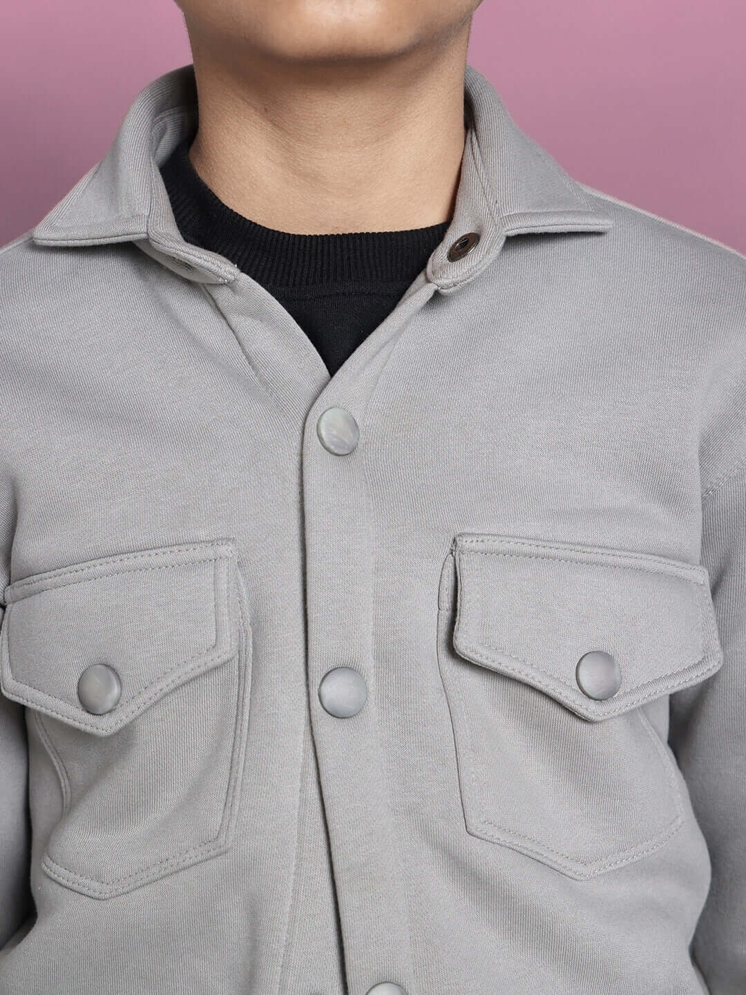 Grey fleece sweatshirt for boys and girls with button-up design and chest pockets, perfect for casual wear.