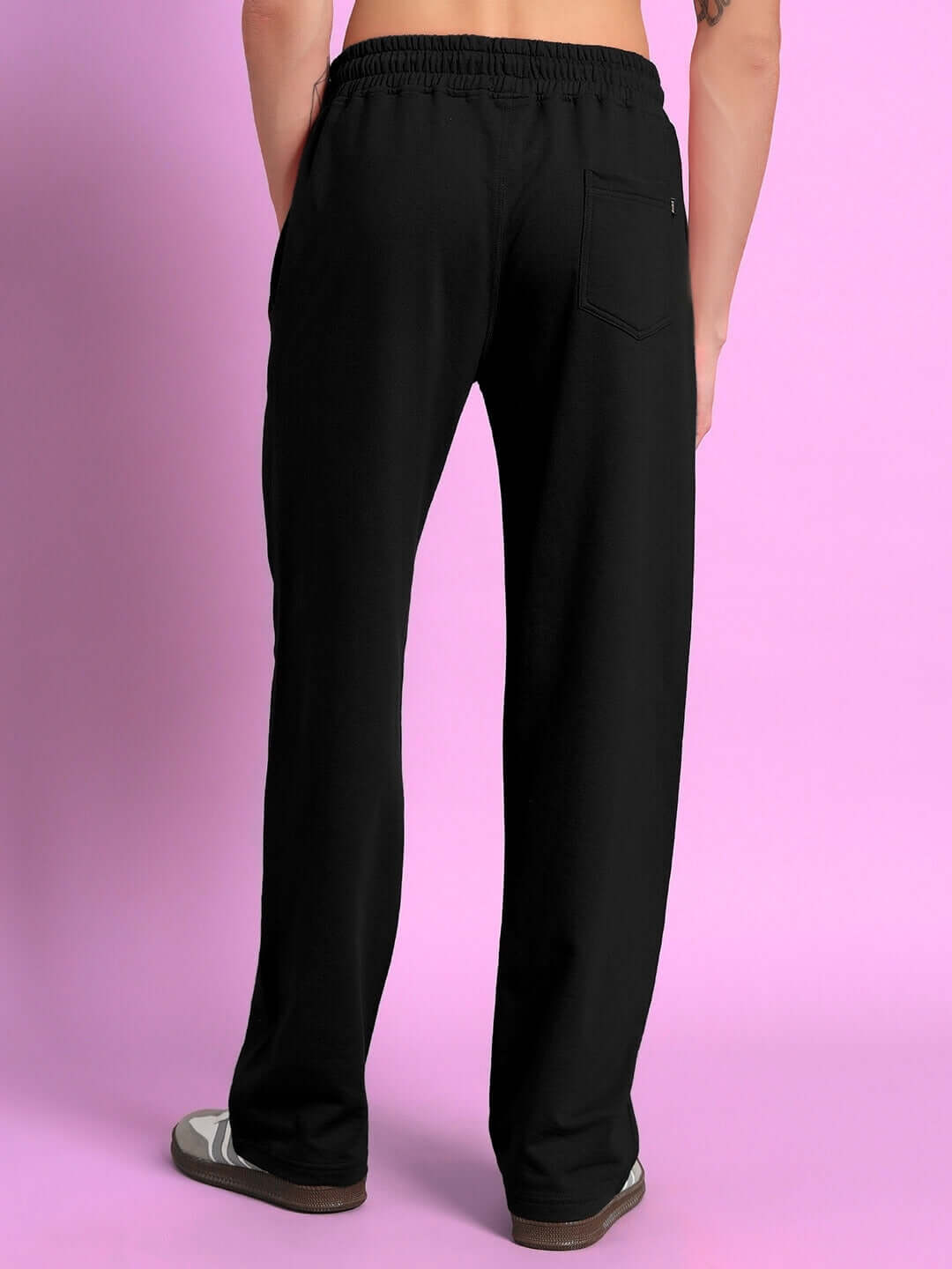 Person wearing black Burning Fire Jogger made-to-order with custom fit option, shown from the back against a pink background.