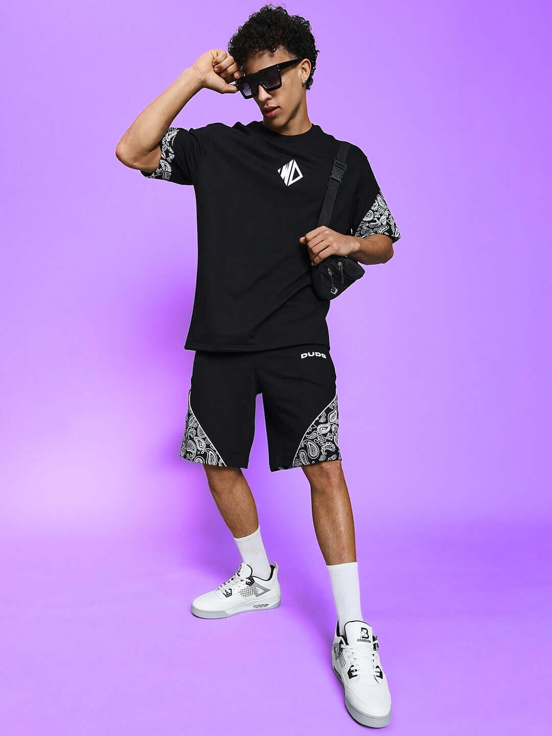 Model wearing CALVIN CO-ORD SET in black with premium cotton fabric, showing the stylish design against a purple background.
