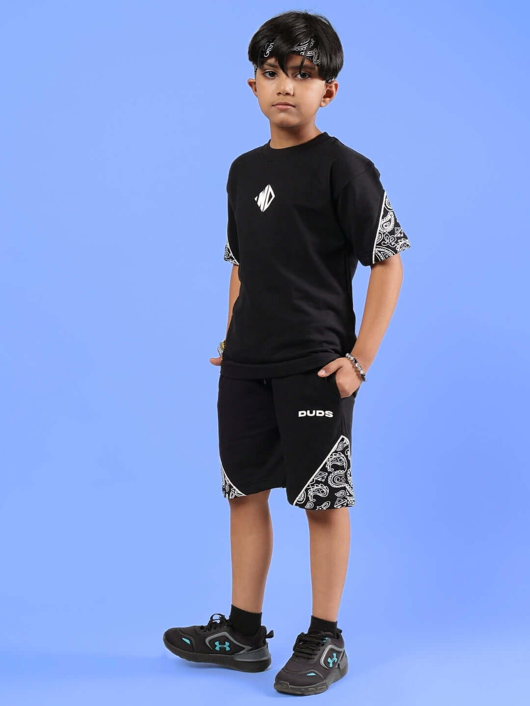 Boy wearing CALVIN SHORTS FOR BOYS & GIRLS BLACK with stylish design by DUDS, customizable for a perfect fit.