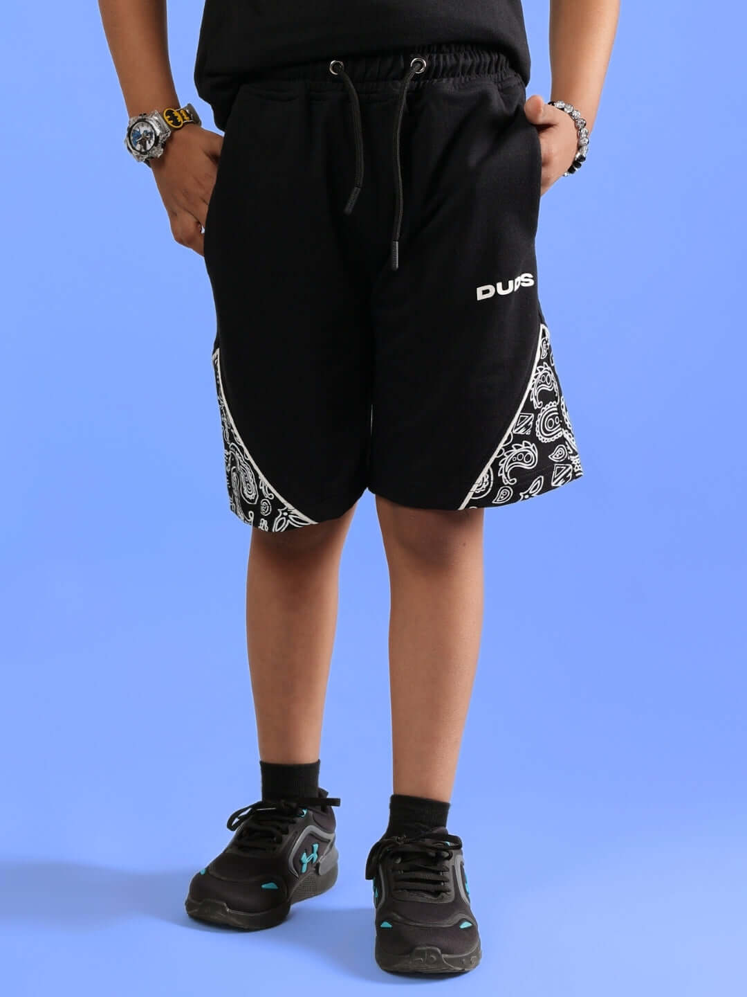 Child wearing black Calvin shorts from DUDS with paisley design, suitable for boys and girls, made by experienced tailors.