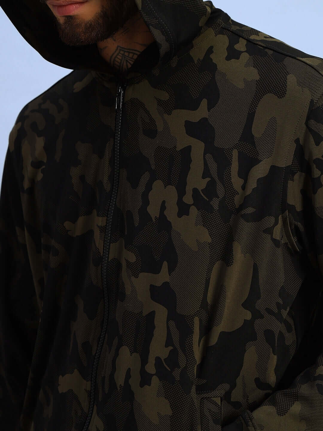 Camo green trench camouflage jacket with hood, detailed design, and zipper finish.