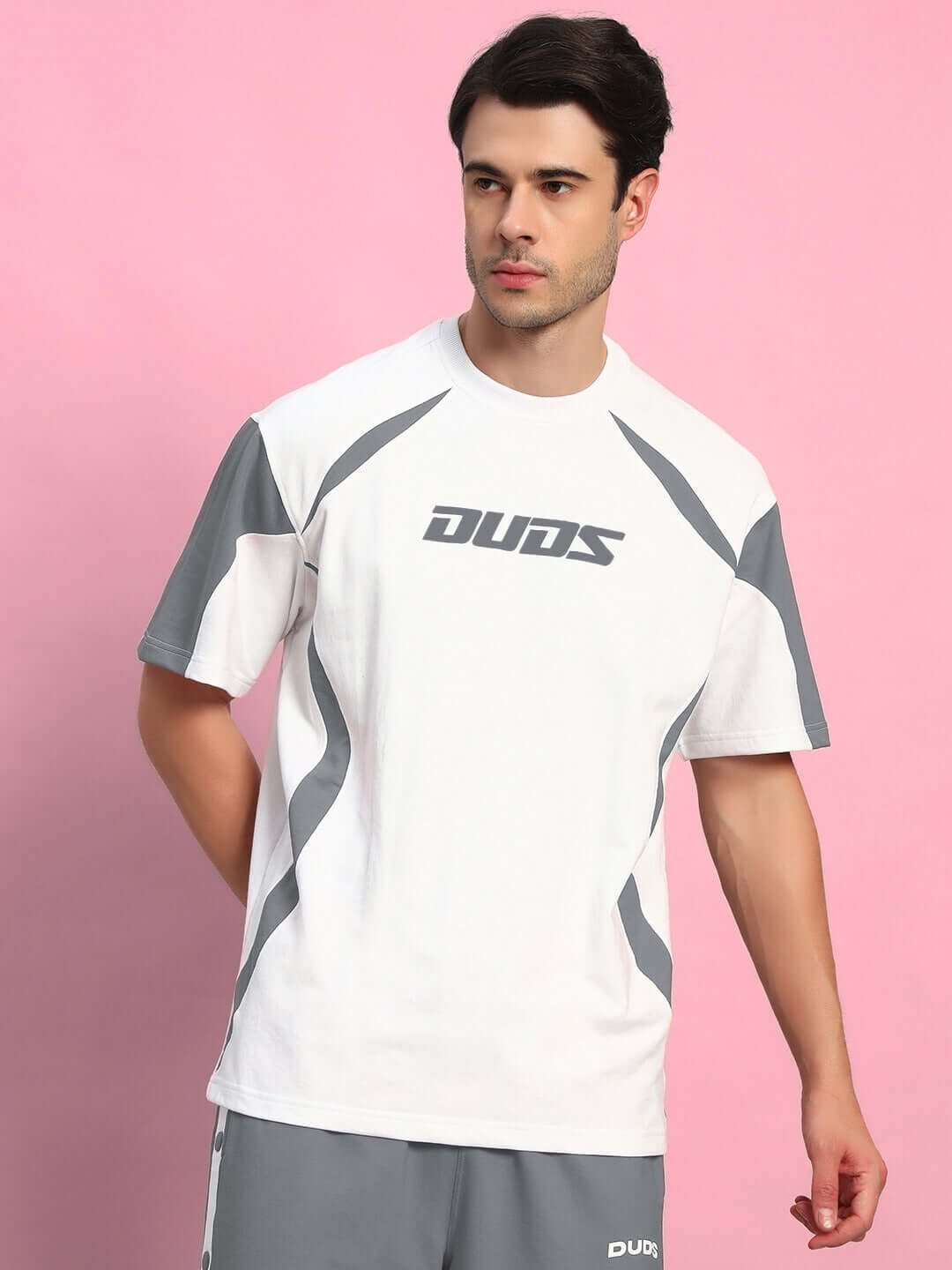 Man wearing Candor oversized t-shirt in white grey, made from premium cotton French terry, showcasing modern casual style.