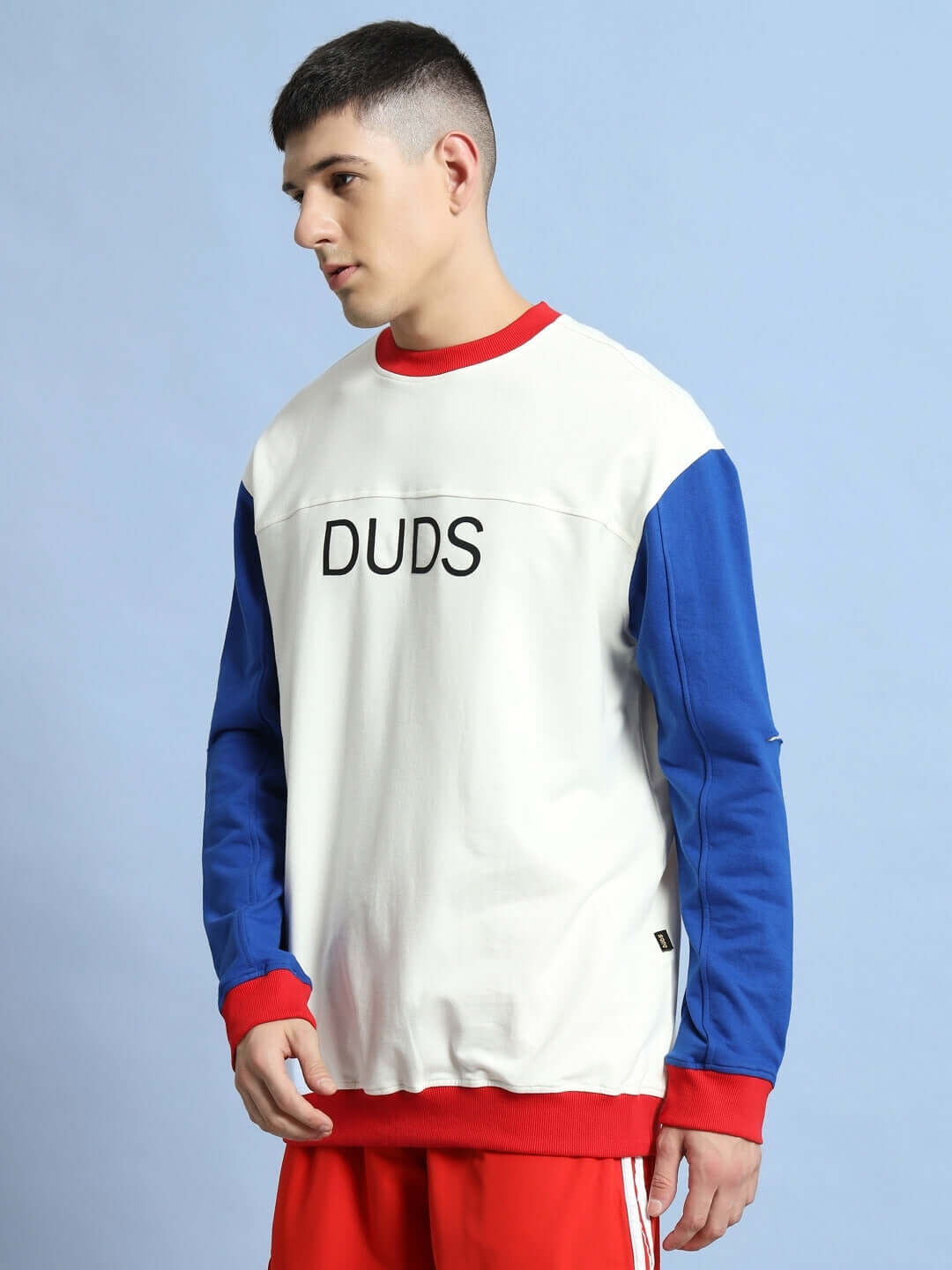 Man wearing Candy Crush Oversized Sweatshirt in multi-color with red, white, and blue design, made from premium cotton, stylish casual wear.