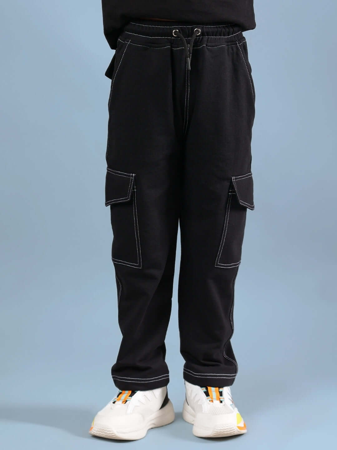 Black carpenter jogger pants for boys and girls with pocket detail, crafted by DUDS, showcased in casual style on a blue background.