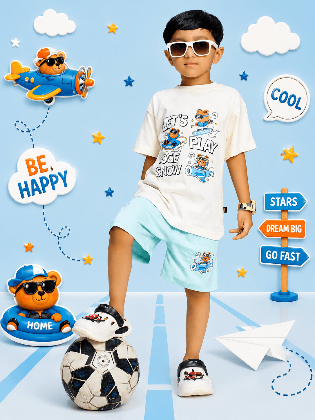 CARTOON BEAR SHORTS FOR BOYS GIRLS MINT GREEN worn by a boy playing with a soccer ball, featuring playful, colorful background elements.