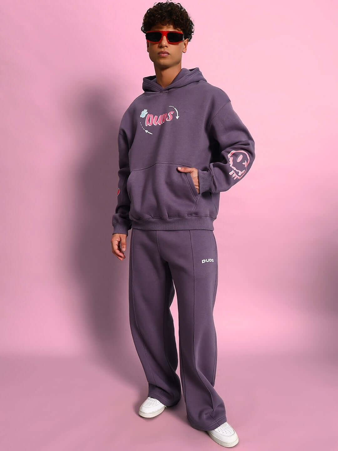 Model wearing CASPER COTTON FLEECE CO-ORD VIOLET, stylish hoodie and joggers, pink background