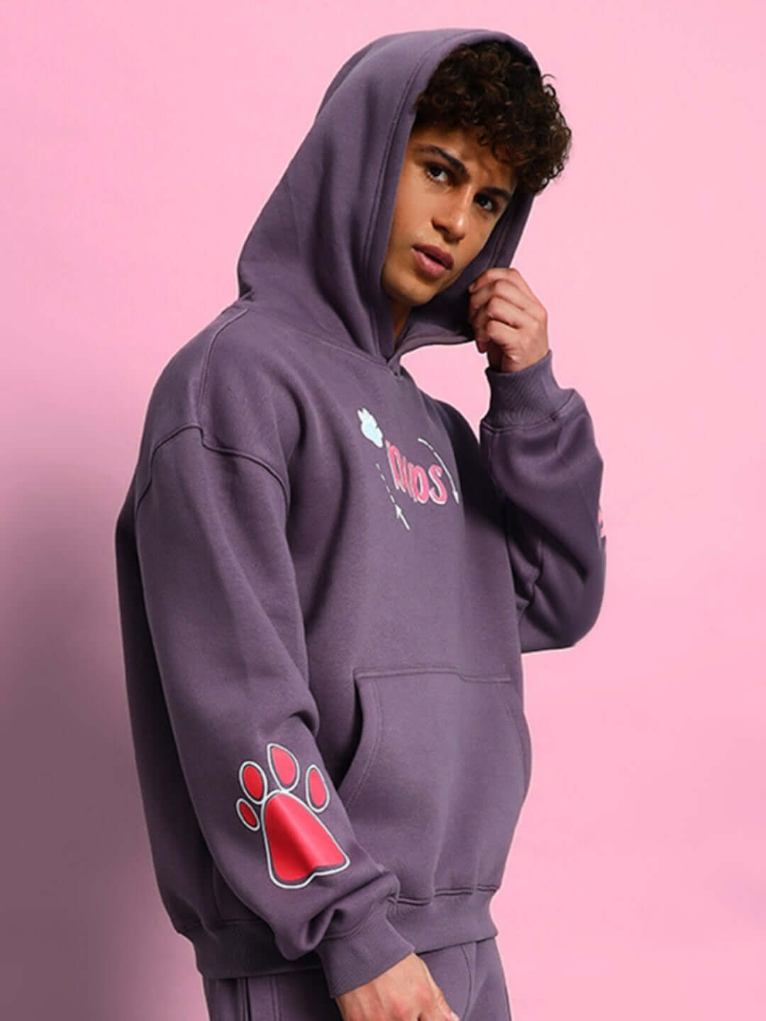 Model wearing CASPER COTTON FLEECE HOODIE VIOLET with paw print design, showcasing its cozy oversized fit and vibrant color.
