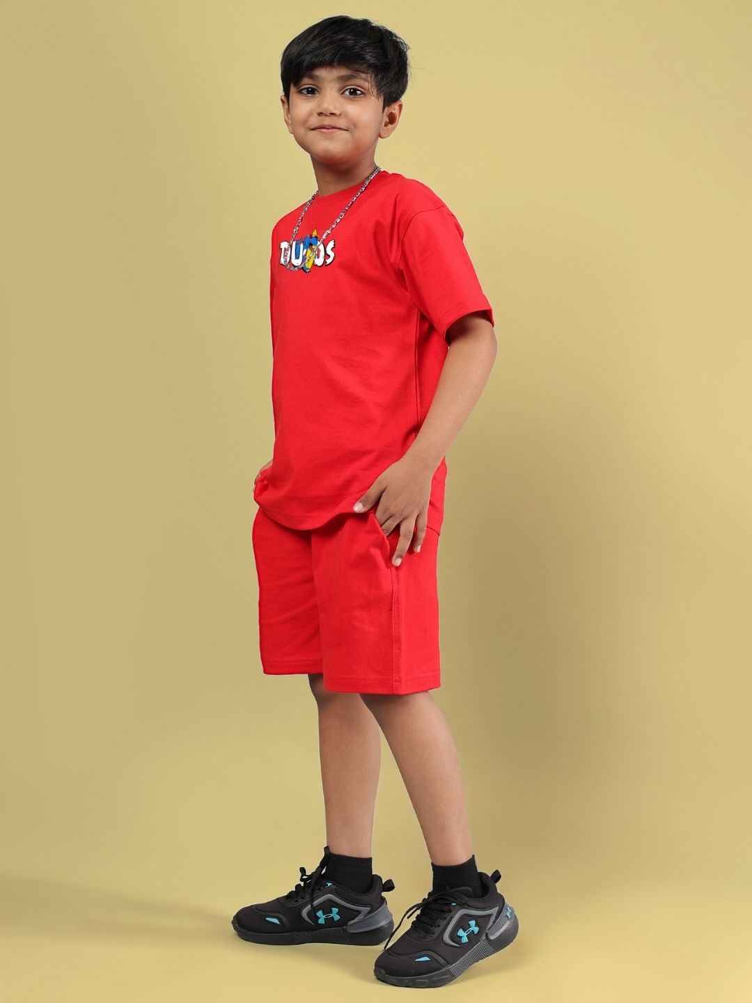 CATCH THE WAVES CO-ORD FOR BOYS & GIRLS RED outfit displayed on model, featuring a vibrant red shirt and shorts set.