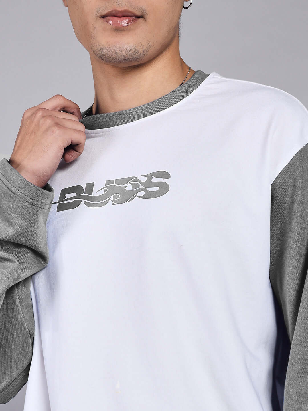 Man wearing grey and white long-sleeve shirt with design on chest