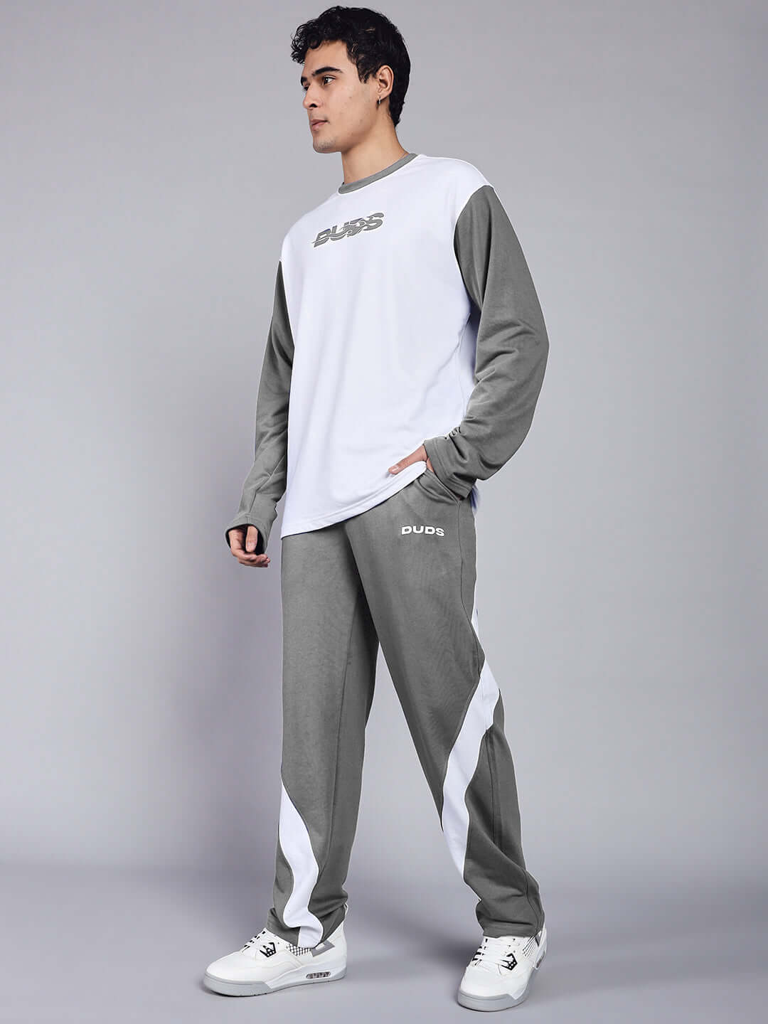 Unisex relaxed fit co-ord set in white and grey, featuring a premium cotton blend, elasticated joggers, and a casual top.