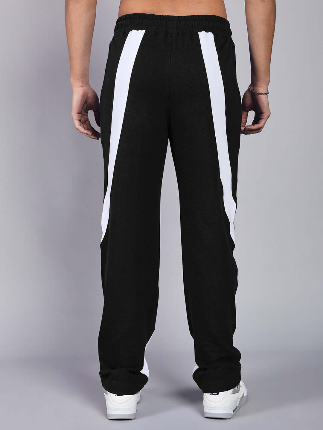 Back view of CELESTINE COOL RELAXED FIT CO-ORD SET WHITE-BLACK pants, showcasing stylish design with white accents on black fabric.