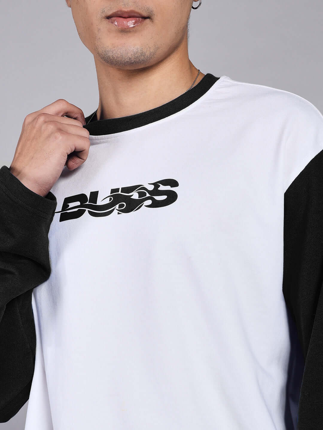 Close-up of CELESTINE COOL RELAXED FIT CO-ORD SET WHITE-BLACK with black sleeves and bold design.