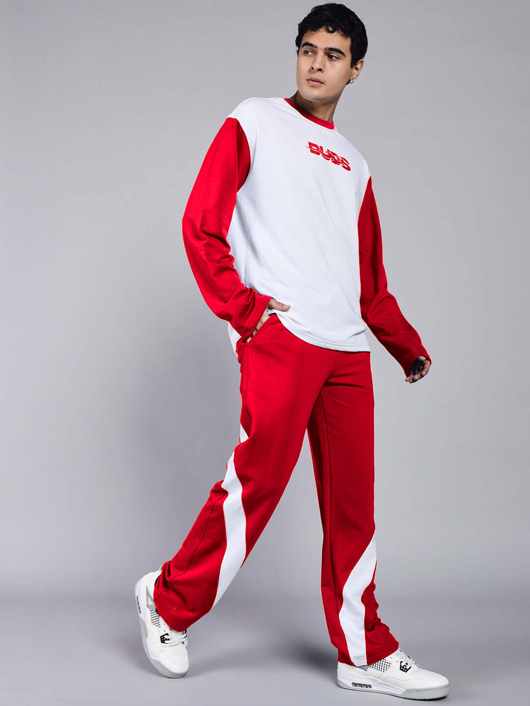 Model wearing Celestine white red relaxed fit co-ord set, featuring unisex joggers with elasticated waistband. Premium cotton blend.