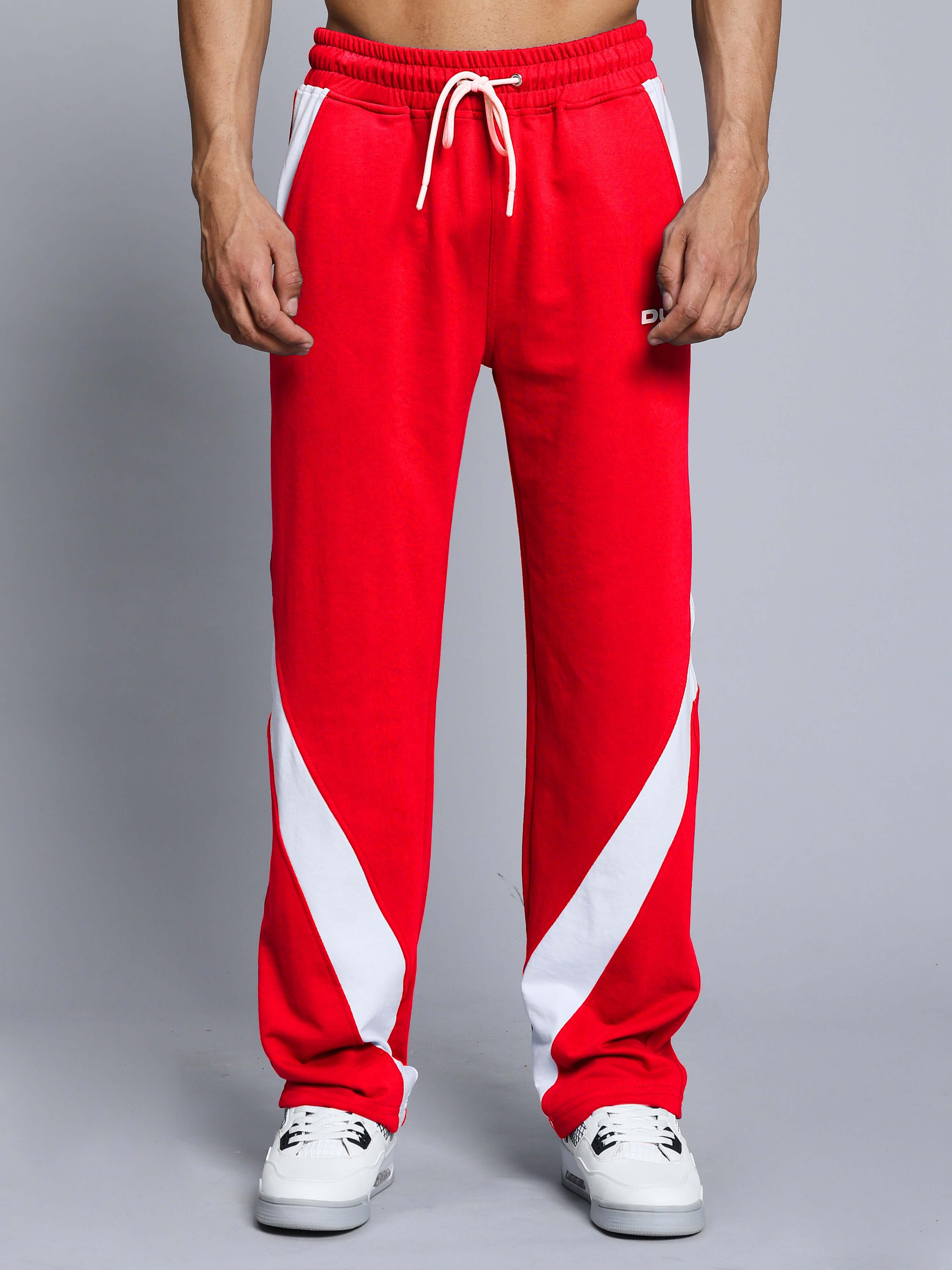 Red and white sporty track pants for men with drawstring waist, side stripes, and relaxed fit.