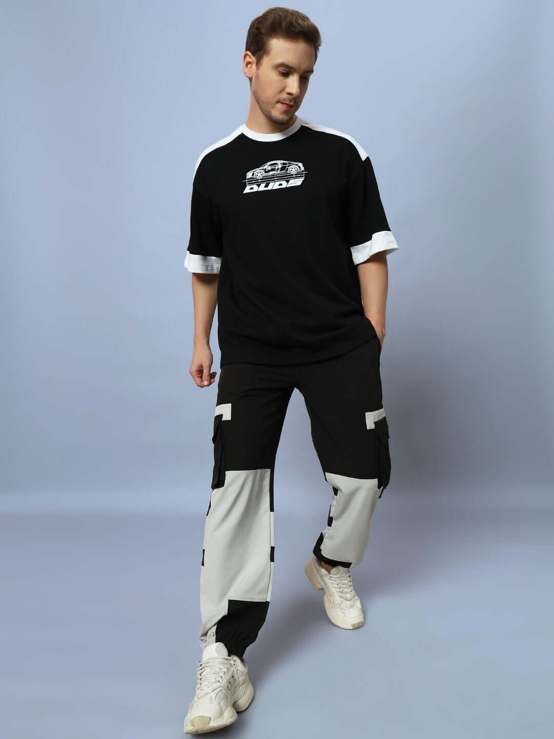 Person wearing Chalet Relaxed Fit Cargo Pants Black Grey with cargo pockets and adjustable waistband for style and comfort.