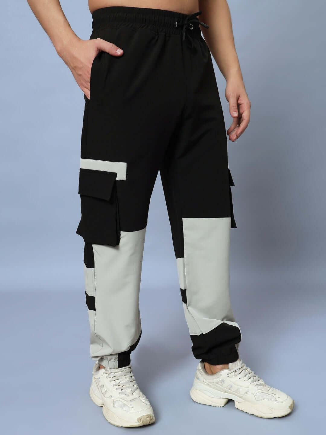 Man wearing Chalet relaxed fit cargo pants in black grey with pockets, showcasing comfortable style and customizable size options.
