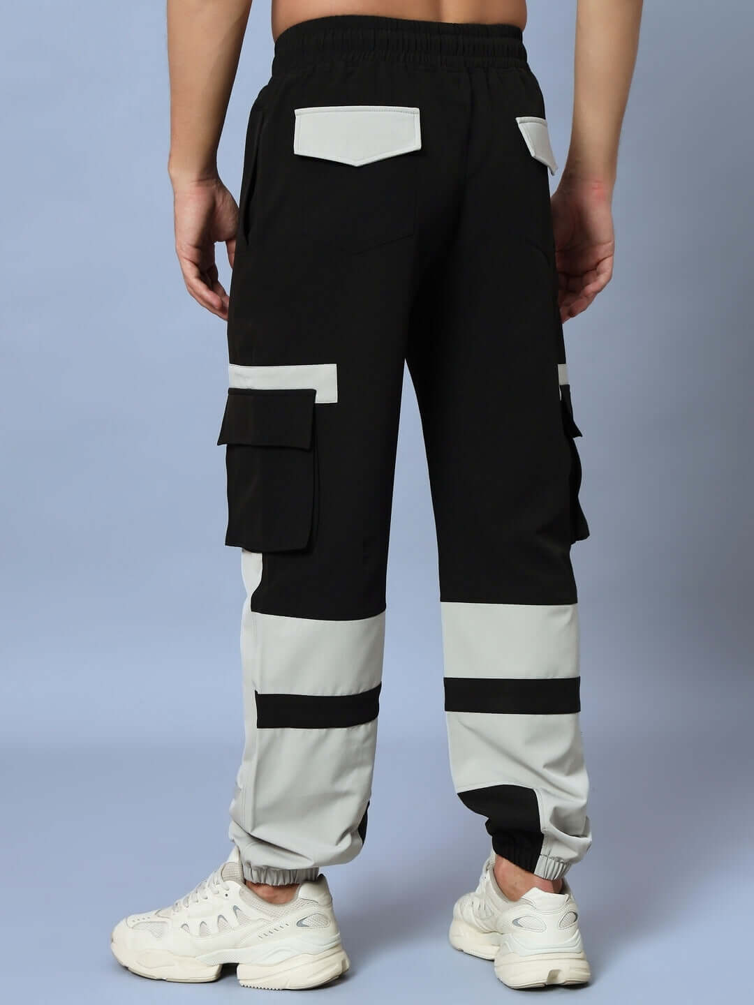 Rear view of Chalet Relaxed Fit Cargo Pants Black Grey showcasing cargo pockets and adjustable waistband.