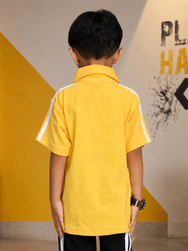 Back view of a child wearing a CHAMPION TRACK POLO T-SHIRT FOR BOYS GIRLS YELLOW with white stripes.