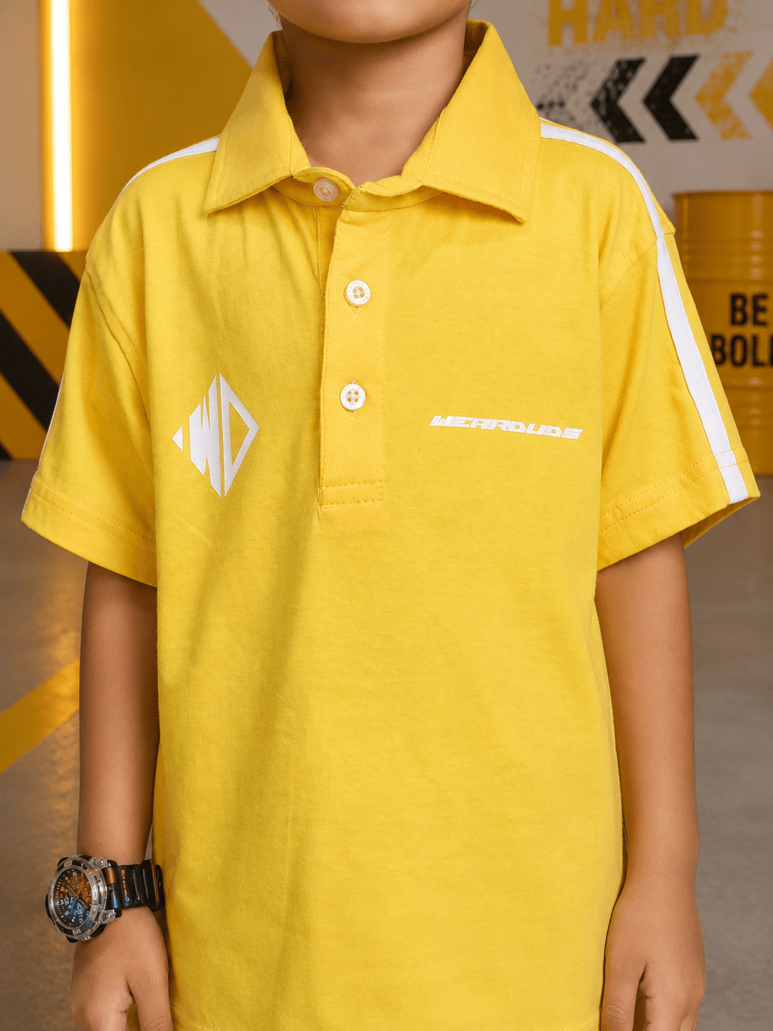 CHAMPION TRACK POLO T-SHIRT FOR BOYS GIRLS YELLOW worn by a child, showcasing the vibrant yellow color and collar design.
