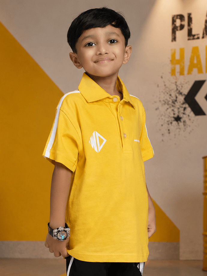 CHAMPION TRACK POLO T-SHIRT FOR BOYS GIRLS YELLOW worn by a smiling boy in a bright yellow polo shirt.