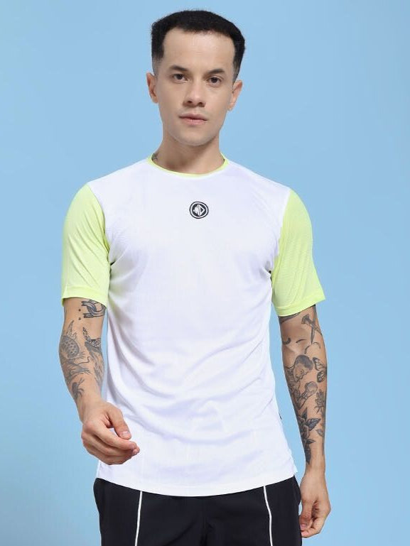 Man wearing CHAMPION ZONE REGULAR FIT T-SHIRT WHITE NEON GREEN with tattoos, blue background