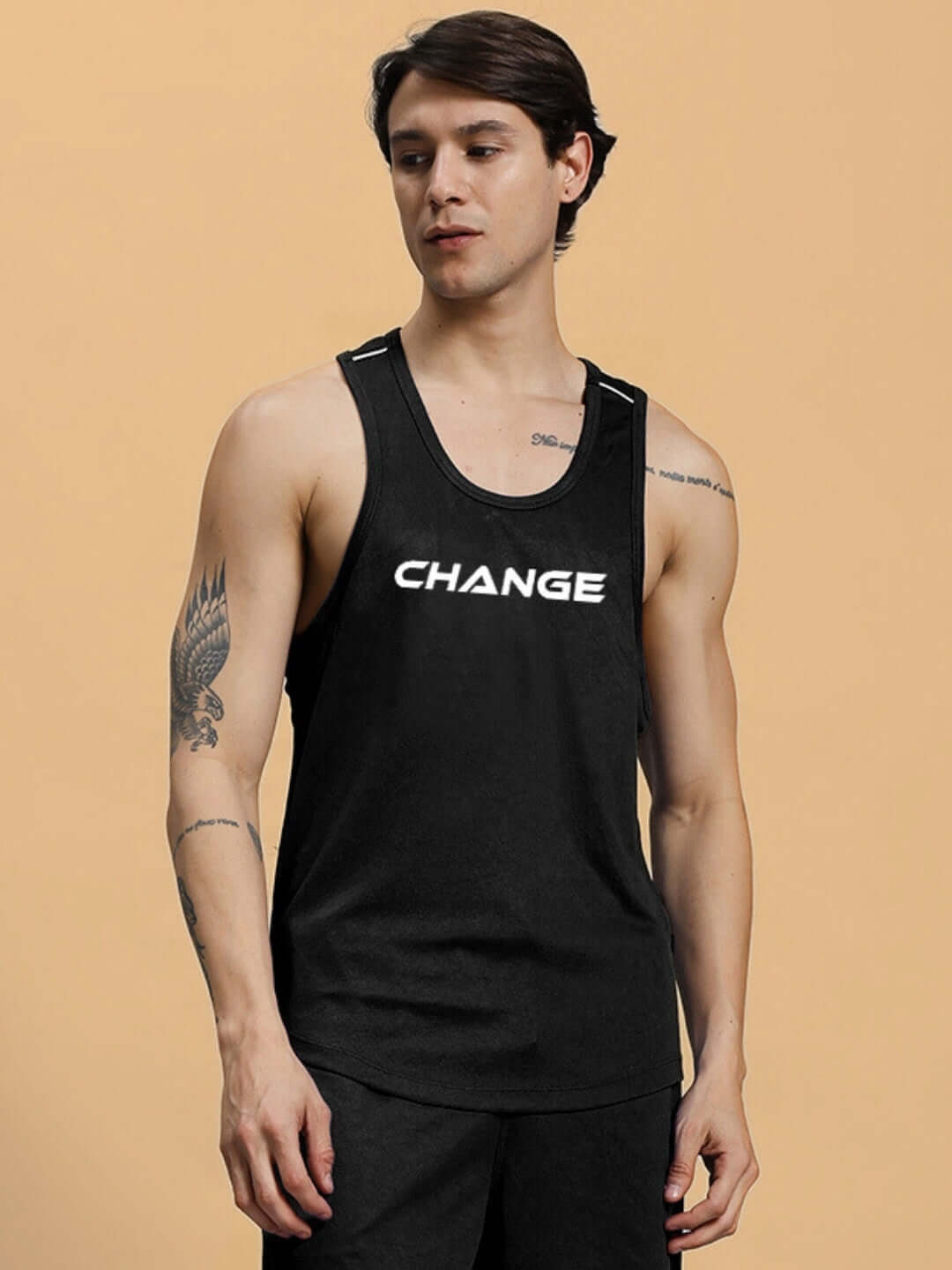 Black gym t-shirt with 'Change' text, customizable fit option available, worn by a person with tattoos on arms.