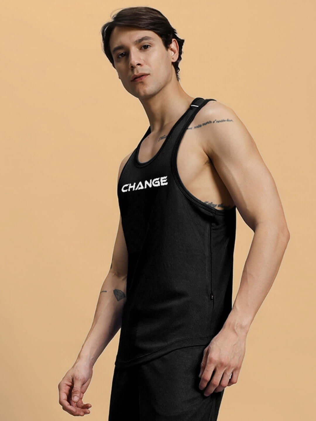 Male model wearing black CHANGE YOUR LOOKS gym T-shirt, showcasing fitness attire.