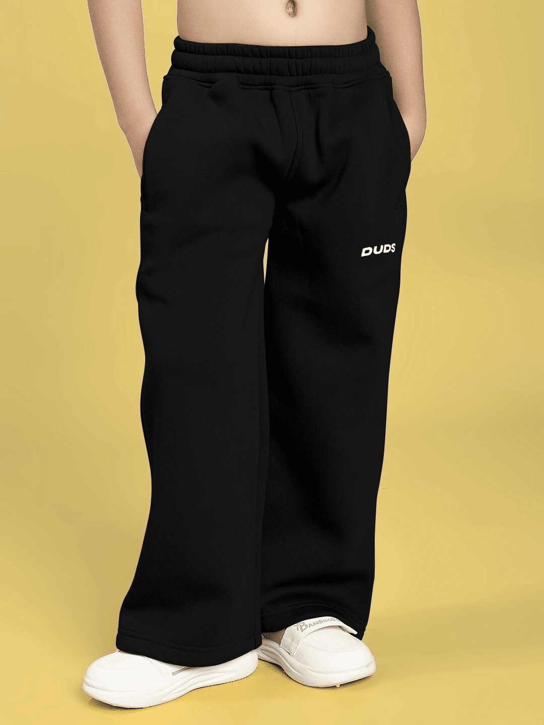 Child wearing CHARMING CARTOON DOGS FLEECE CO-ORD FOR BOYS AND GIRLS BLACK showcasing black fleece pants with cartoon graphics.