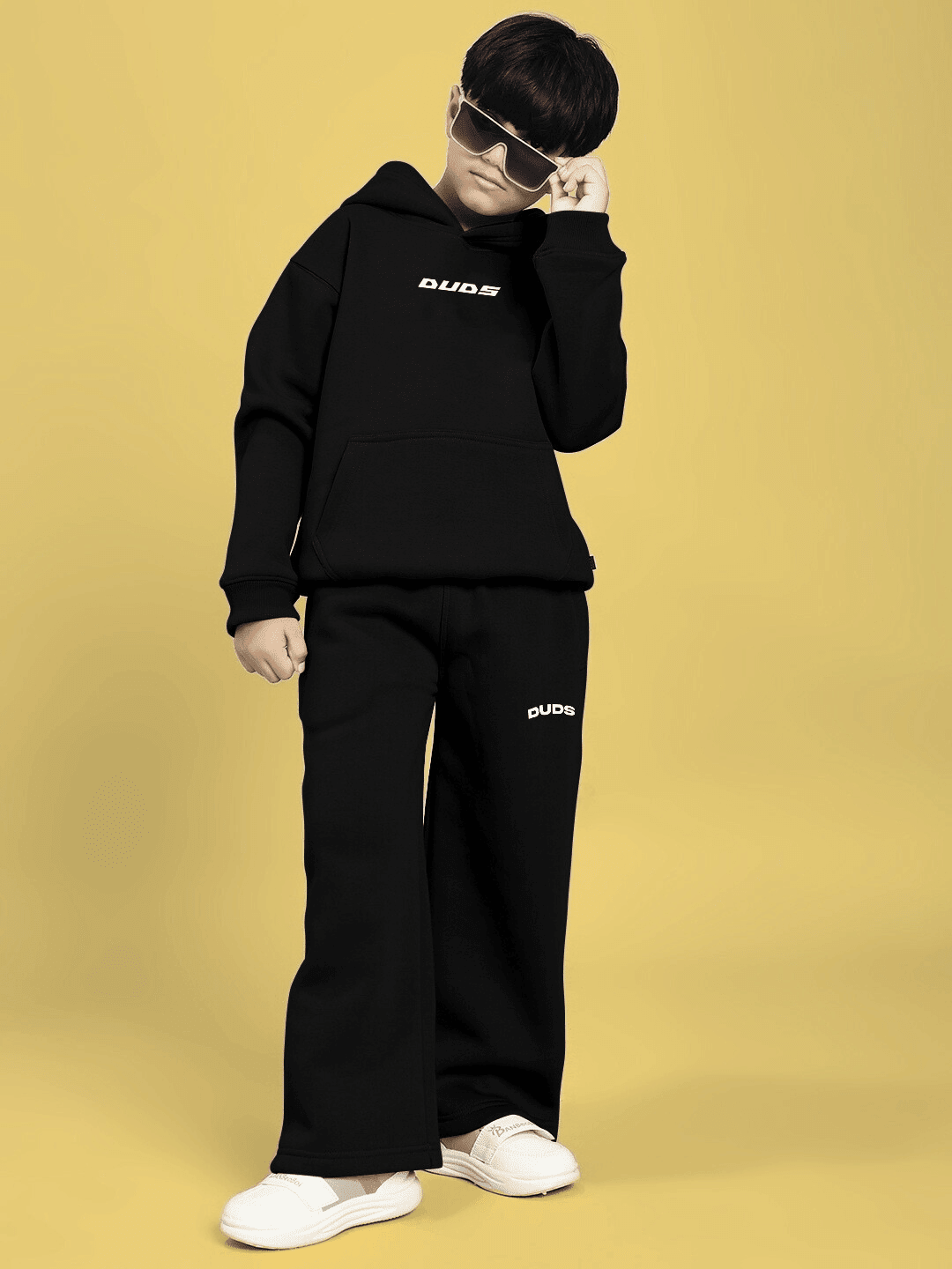 Boy wearing CHARMING CARTOON DOGS FLEECE CO-ORD FOR BOYS AND GIRLS BLACK with sunglasses, showcasing a trendy and playful outfit