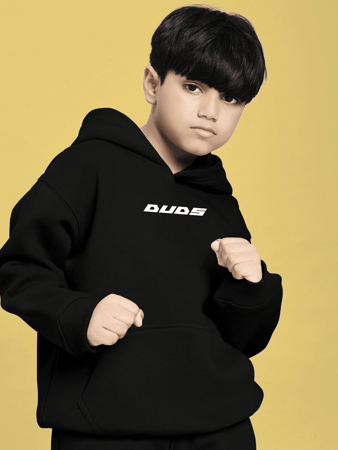 Boy wearing CHARMING CARTOON DOGS FLEECE HOODIE FOR BOYS AND GIRLS BLACK, playful and cozy hoodie with cartoon dog graphics for kids.