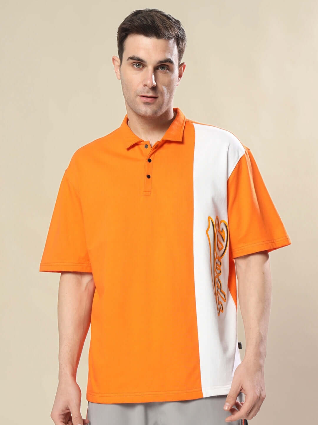 Man wearing CHEUGY oversized orange-white polo T-shirt, premium cotton French terry fabric, showcasing stylish and comfortable design.