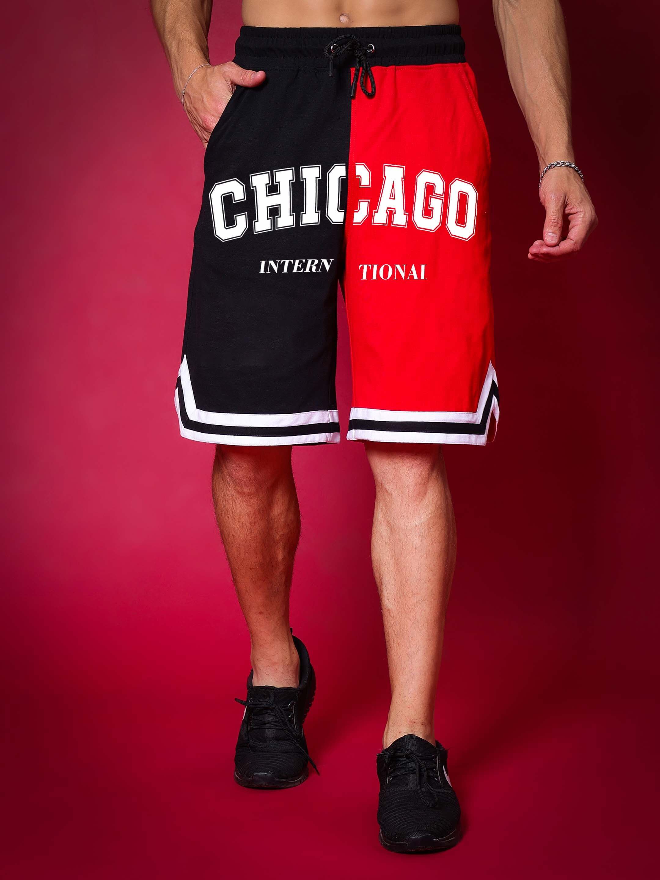 Man wearing Chicago Regular Fit Shorts in red and black with bold letters, suitable for custom size options and handmade quality.