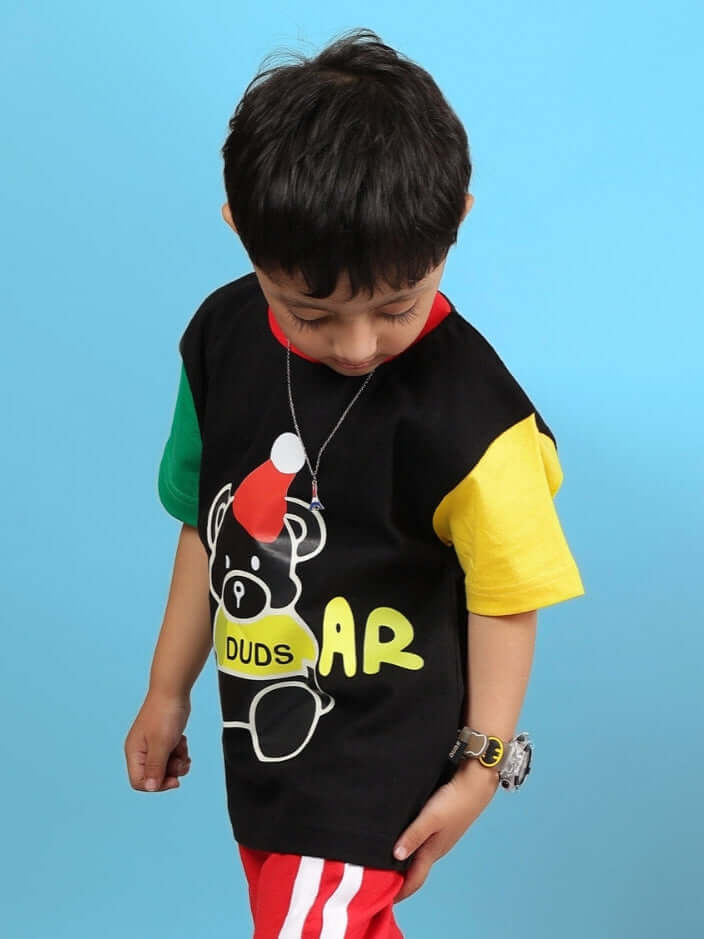 MOCHA T-SHIRT FOR BOYS GIRLS BLACK worn by child, colorful design, blue background.