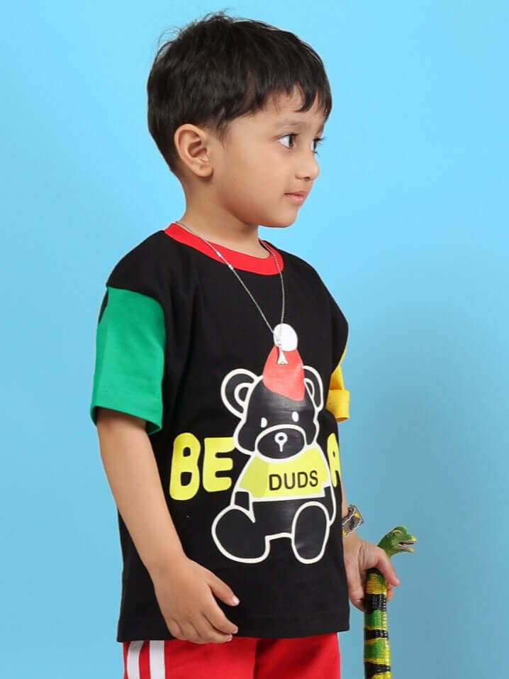 Child wearing MOCHA T-SHIRT FOR BOYS GIRLS BLACK with bear design on blue background.