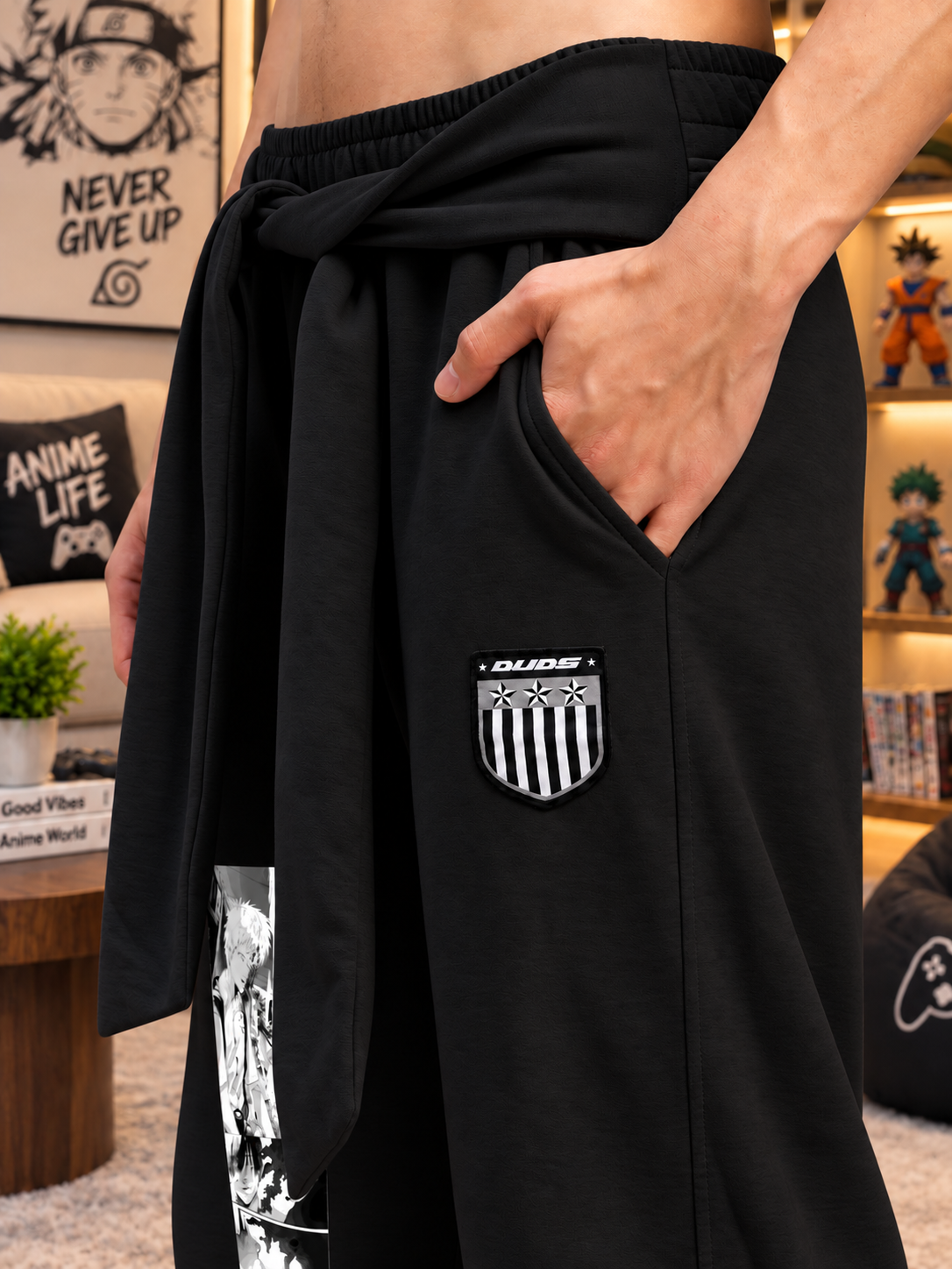 CHILL GRAPHIC COTTON TERRY JOGGERS BLACK with drawstring waist and shield logo pocket detail, styled with anime decor