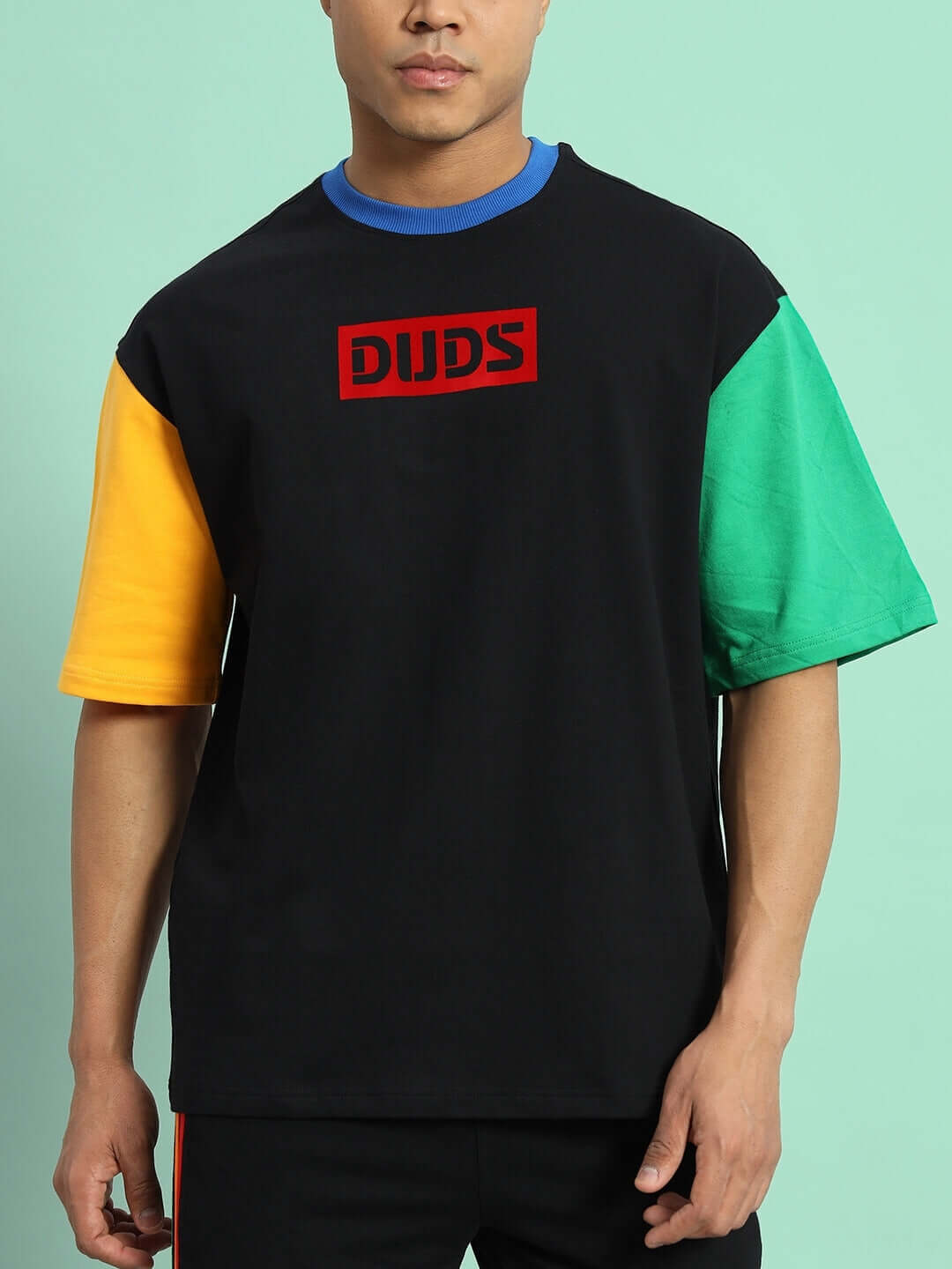 Chroma color blocked oversized black t-shirt with multicolor sleeves, featuring premium cotton blend, worn by model in front view.