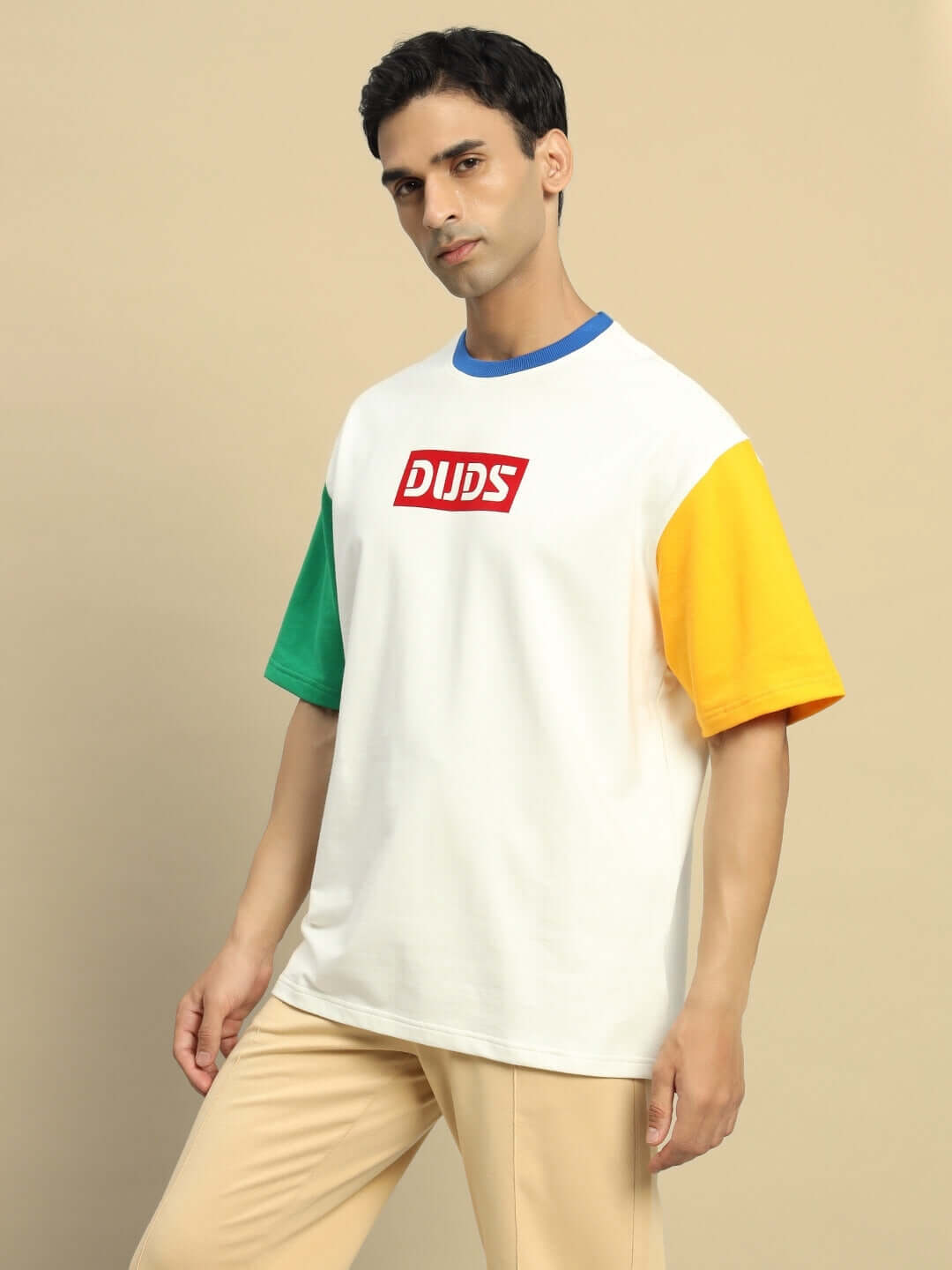 Chroma color blocked oversized t-shirt in off white with green, yellow sleeves, made from premium cotton fabric, worn by a model.