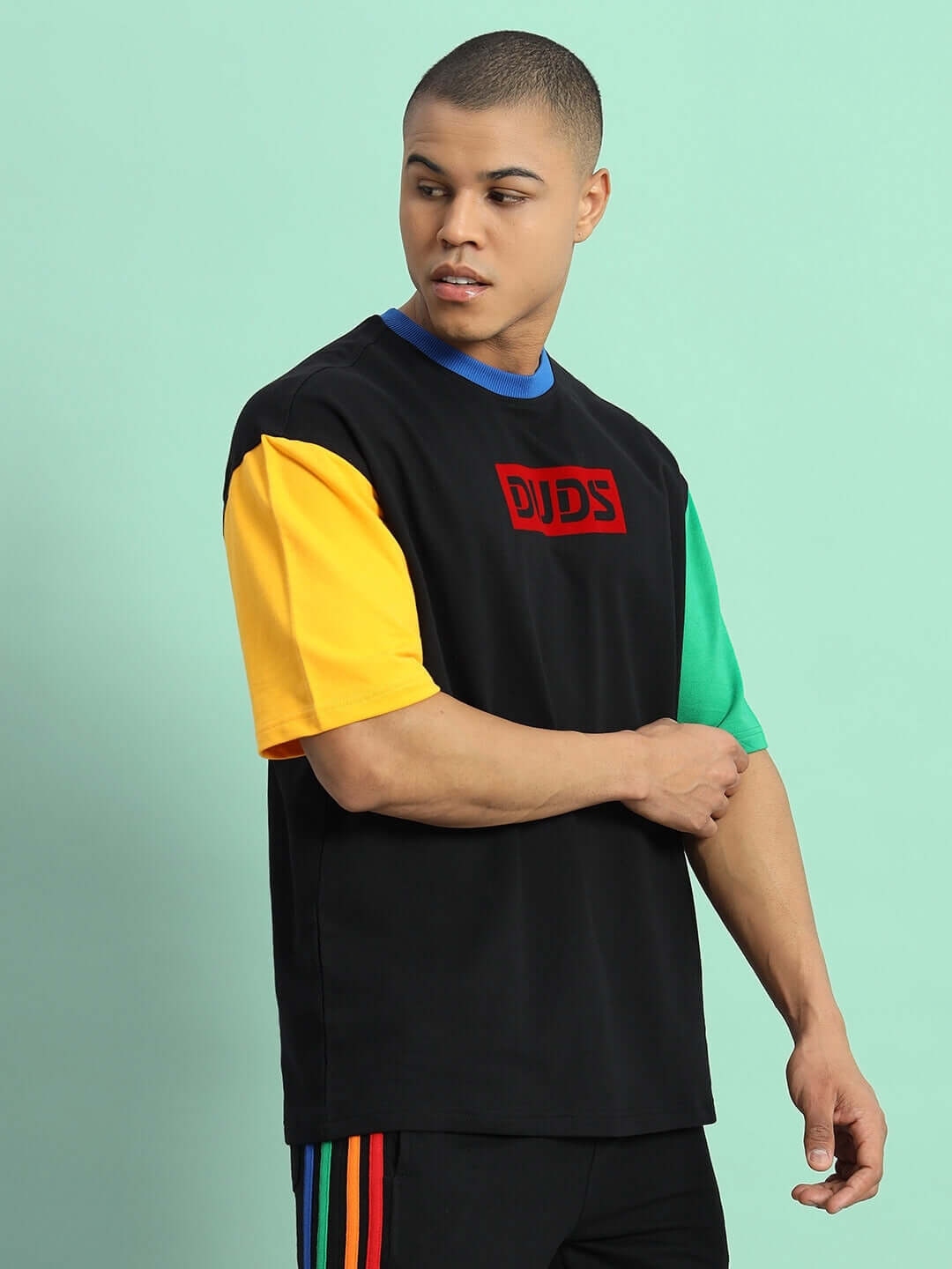 Model wearing Chroma color blocked oversized t-shirt in black, featuring premium cotton fabric with multicolor sleeves.