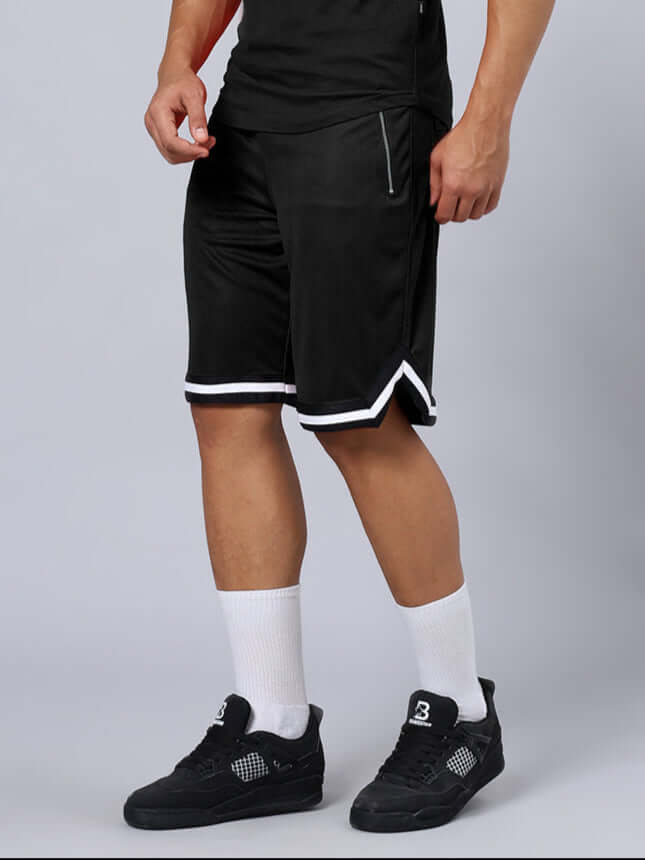 Man wearing CHRONIC REGULAR FIT SHORTS BLACK with white sneakers