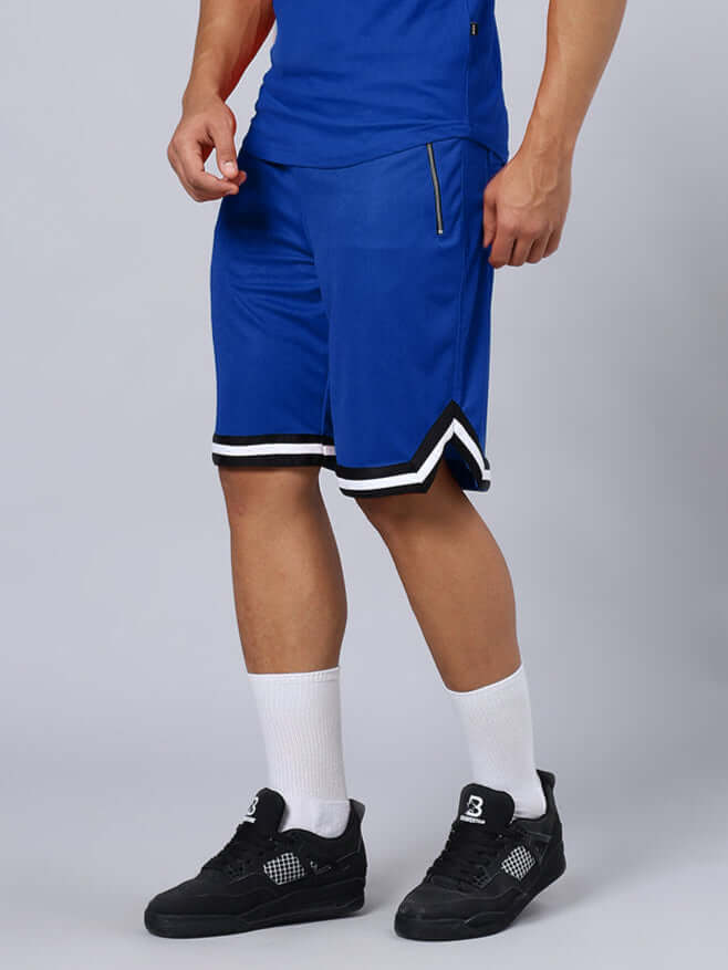 Model wearing blue Chronic Regular Fit Shorts with black and white trim, showcasing sporty streetwear style.