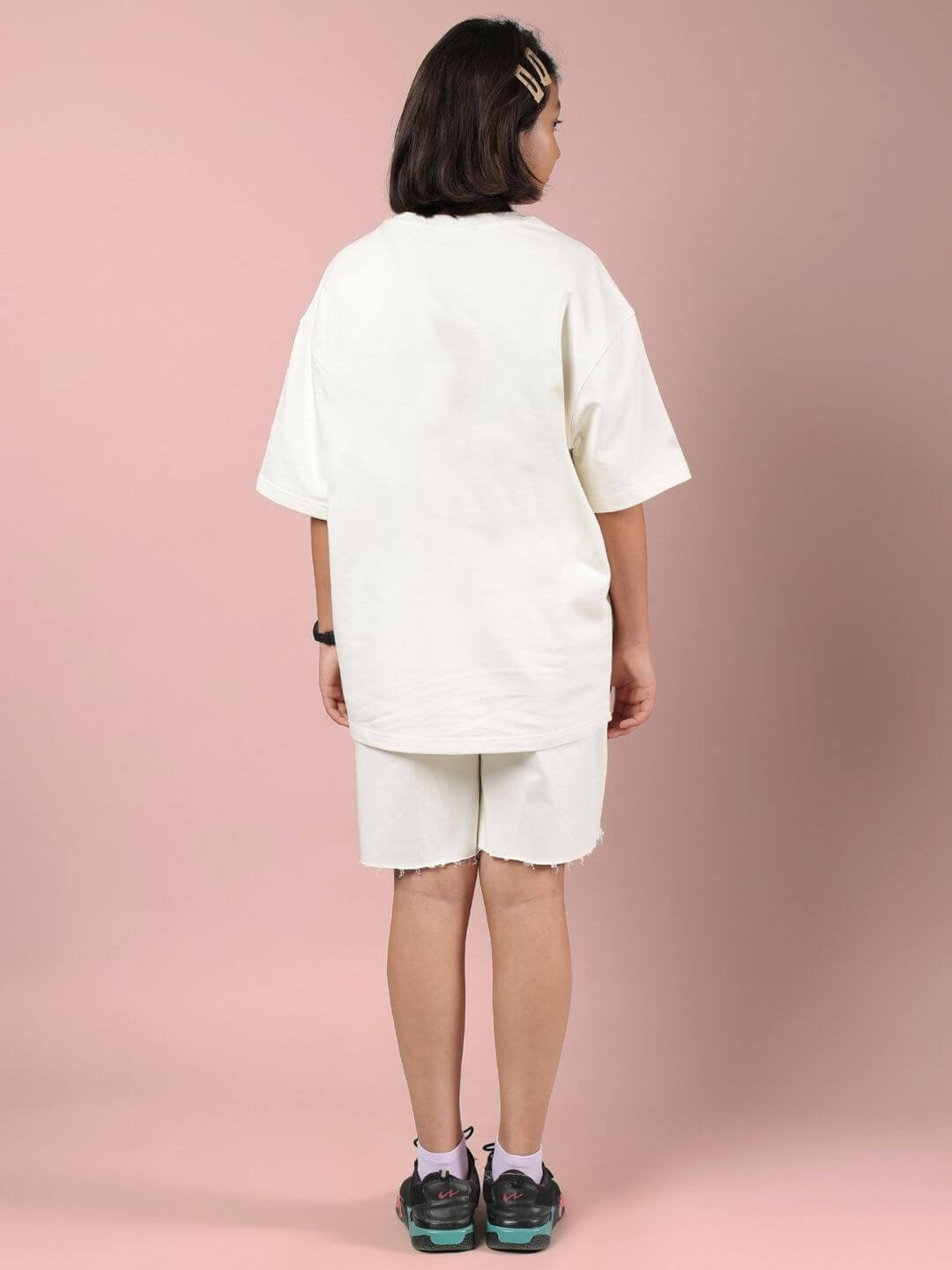 Back view of a model wearing CLOUD PRINTED CO-ORD FOR BOYS AND GIRLS OFF WHITE, showcasing its relaxed fit and design.