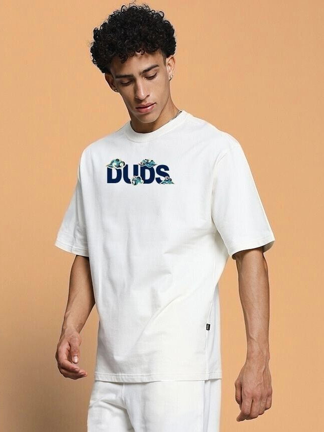 Model wearing CLOUD PRINTED OVERSIZED T-SHIRT OFF WHITE, featuring a cloud design on soft cotton for a trendy street-chic look.