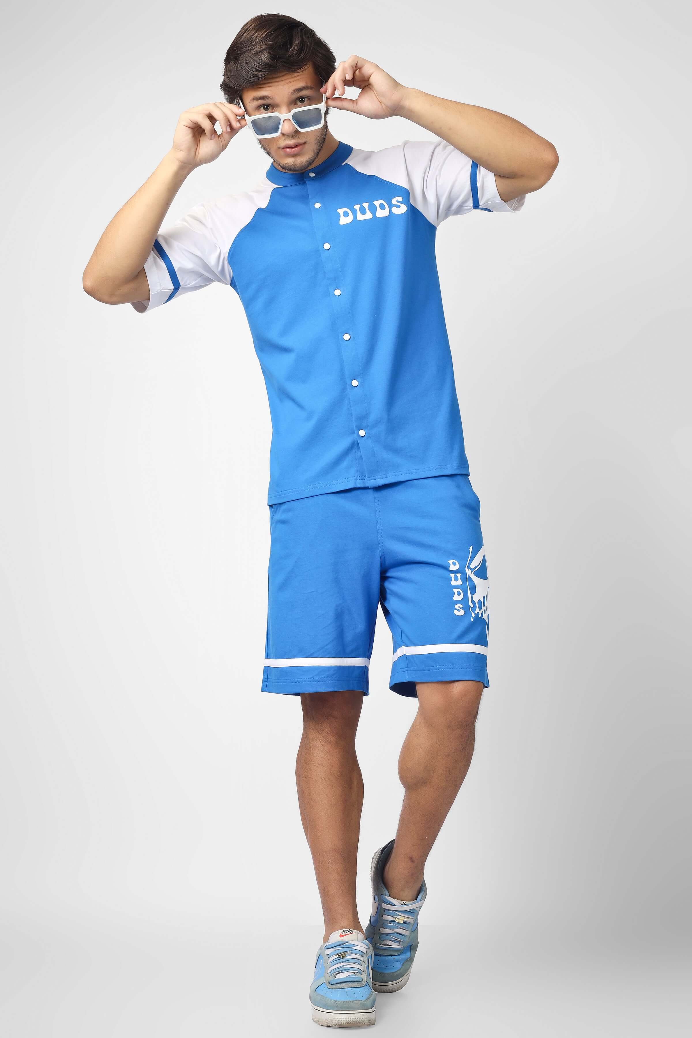 Model wearing CO-ORD SET WITH SKULL BUTTERFLY PRINT BLUE, featuring a bold skull and butterfly design on blue fabric.
