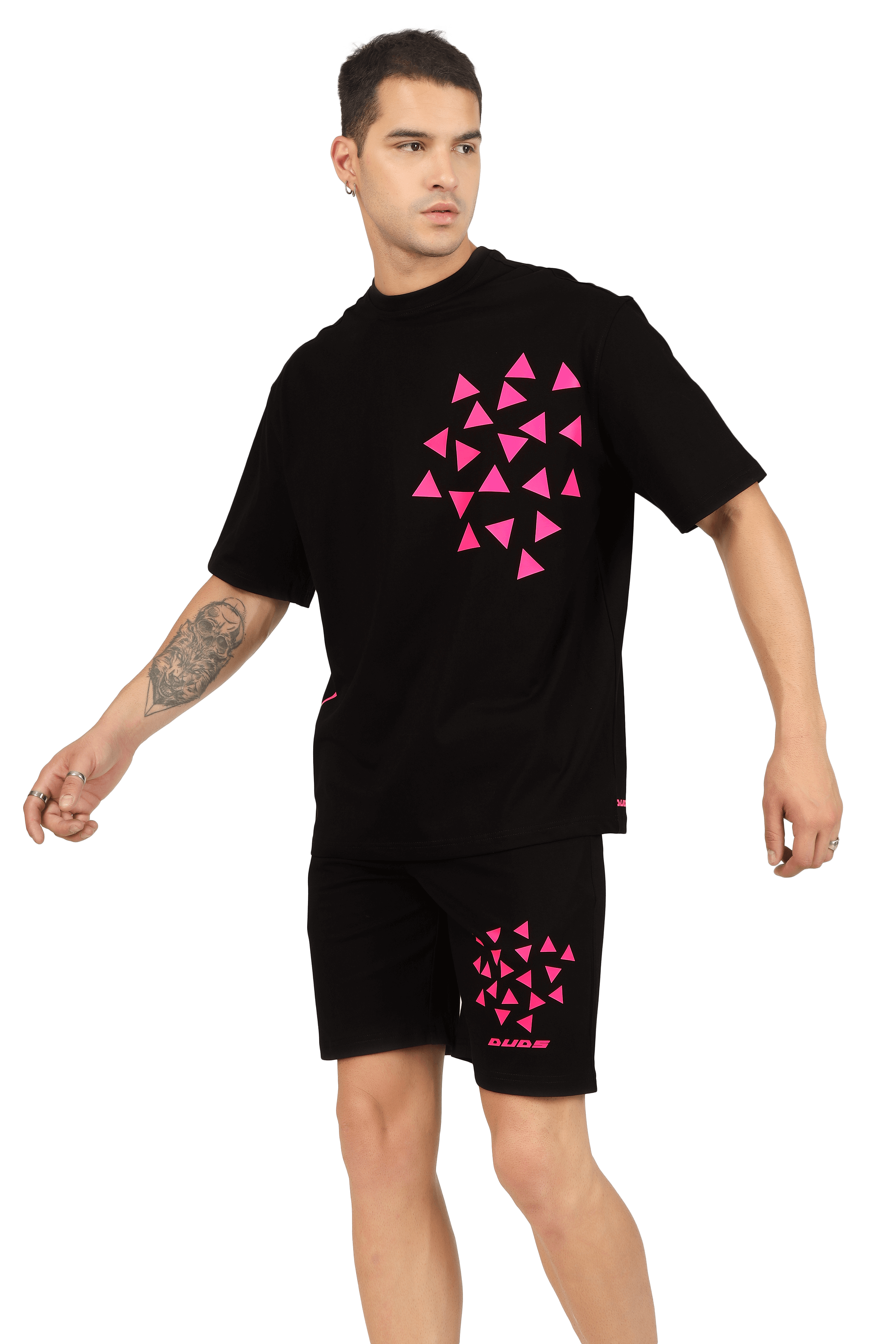 Man wearing black CO-ORD SET with pink star dust print on shirt and shorts, customizable size option available, handmade by DUDS